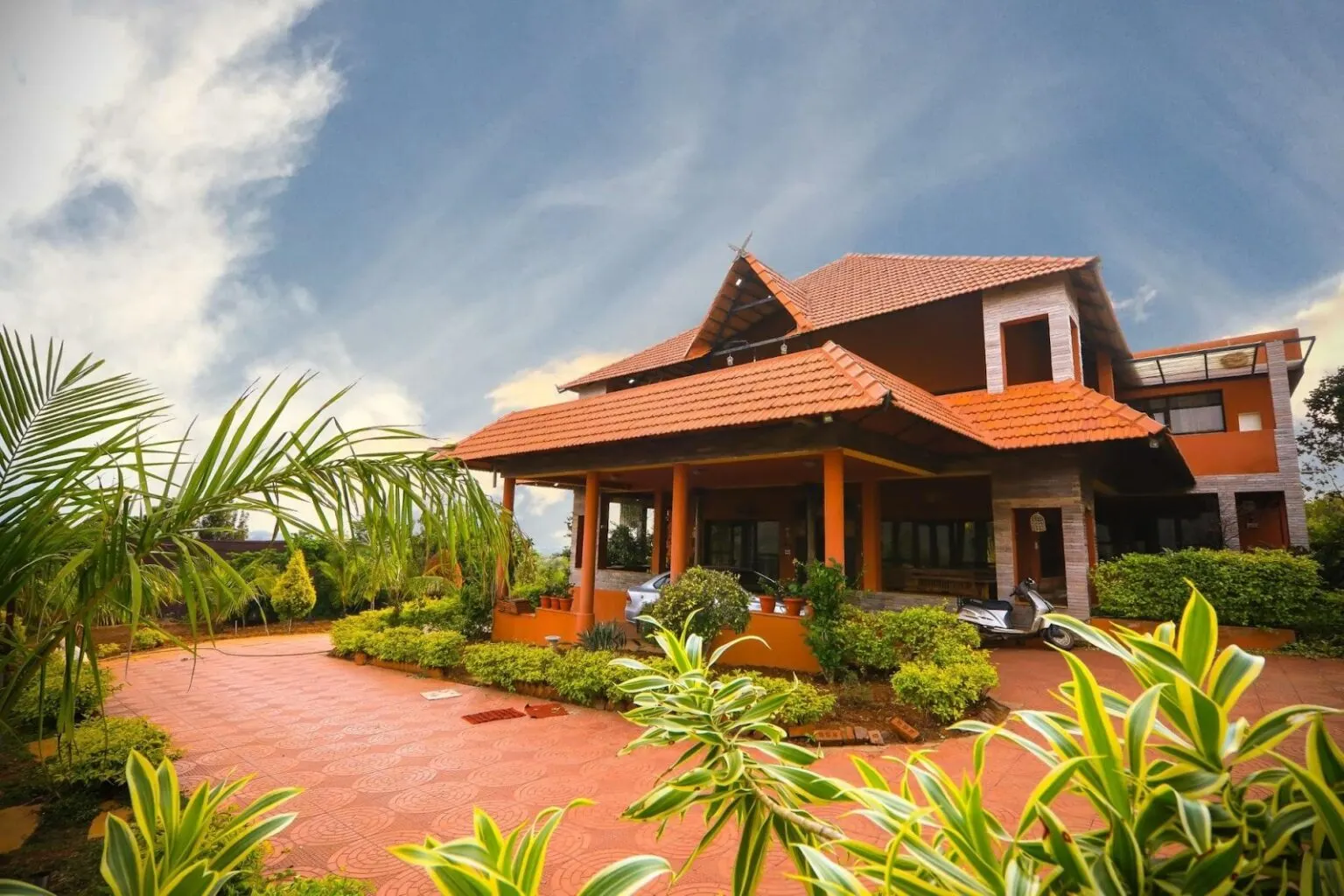 A spacious tiled-roof villa with landscaped gardens in a green Bangalore suburb