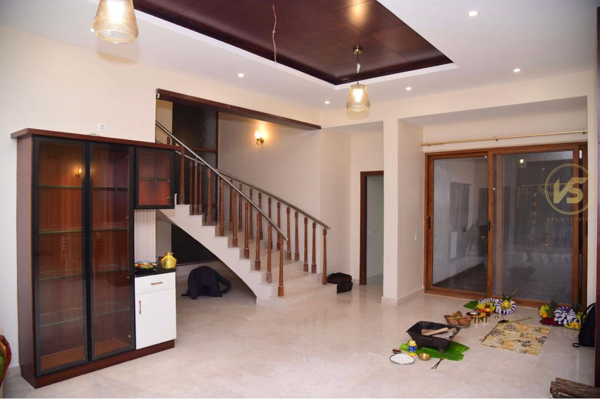 A bright modern home interior with a wooden staircase and double-height living area